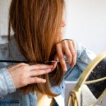 A woman cutting her own hair